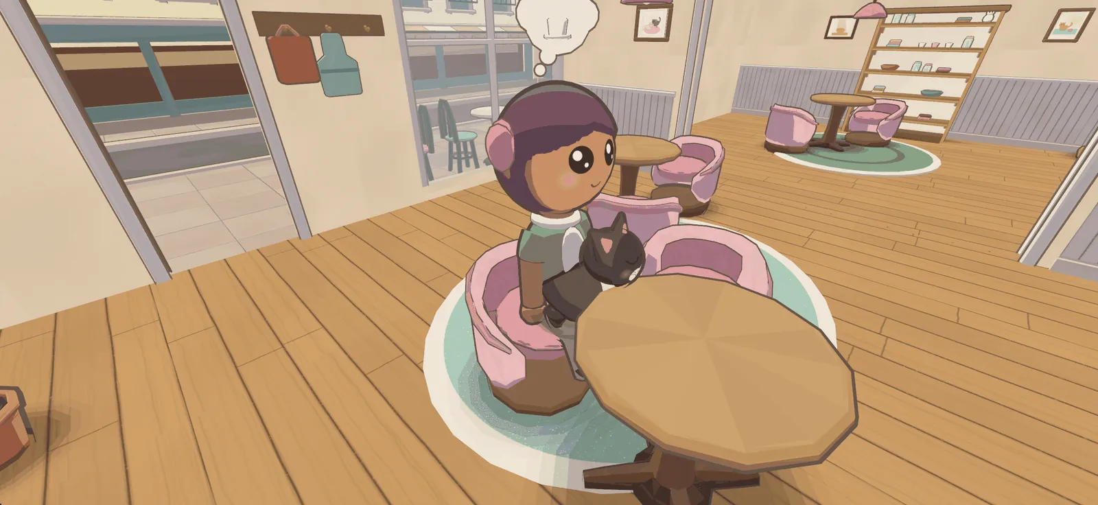 A cat asleep on a guest's lap at her table, her hand resting on it.